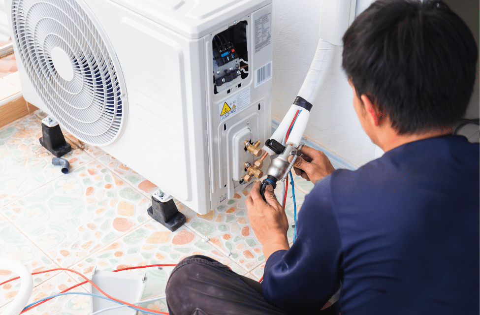 Engineer working on an air conditioning unit