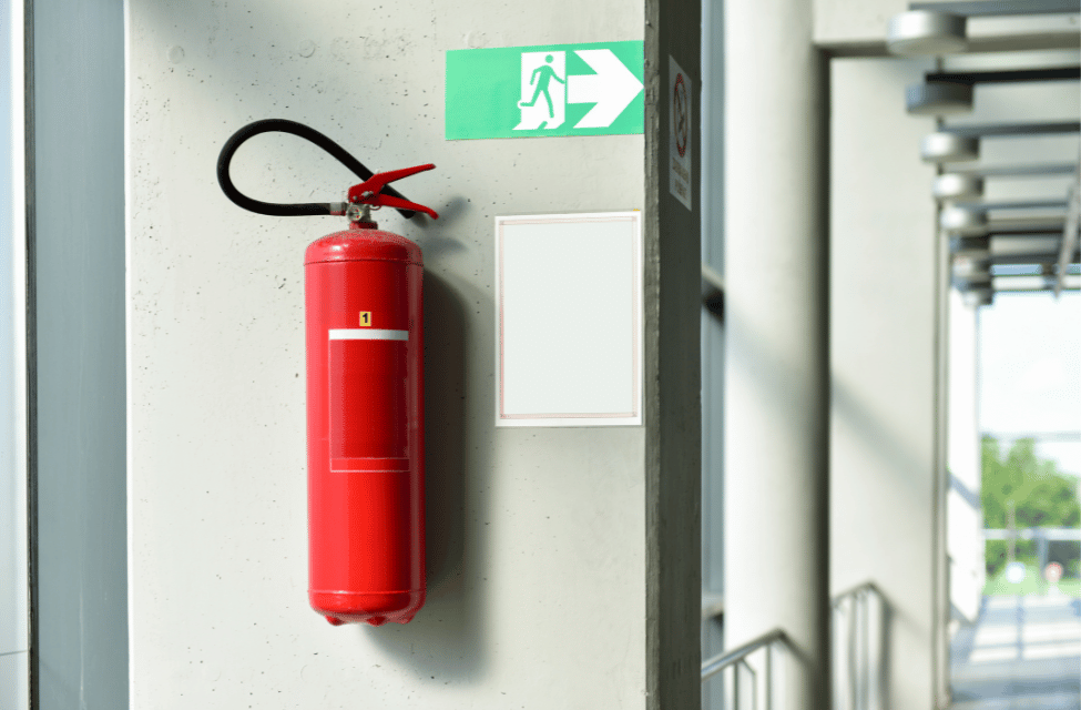 a red fire extinguisher on a wall
